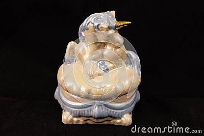 Small blue and gold ceramic unicorn jewelry box Stock Photo