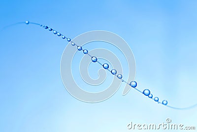 small blue water droplets hanging on fishing line Stock Photo