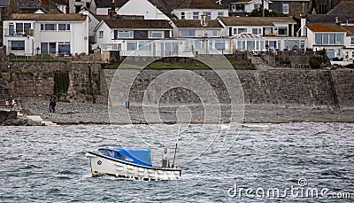 Small boat ferrying passengers across choppy sea from Marazion to St Michael`s Mount in Marazion, Cornwall, UK Editorial Stock Photo