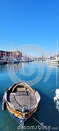 a small boat in the Italian port of Genoa, Liguria Editorial Stock Photo