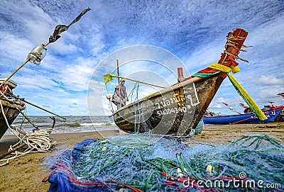 A small boat local fishery group is removing crabs, fish and sea creatures caught from their nets at Jomtien Beach Editorial Stock Photo