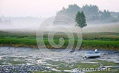 Small boat at low tide Stock Photo
