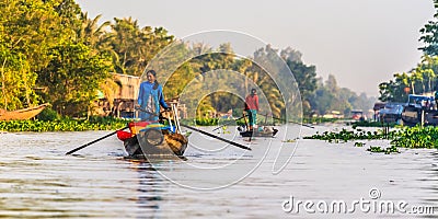 Small boat transporting people go and back to the floating market in Mekong River, Vietnam Editorial Stock Photo