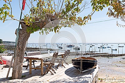 Small boat vintage and terrace at seaside in village of Cap Ferret in Bassin Arcachon France Stock Photo