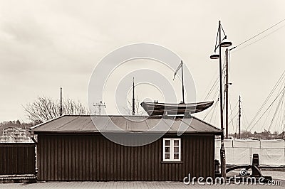 Small boatyard on the pier. Boat garage with boat on the roof Stock Photo