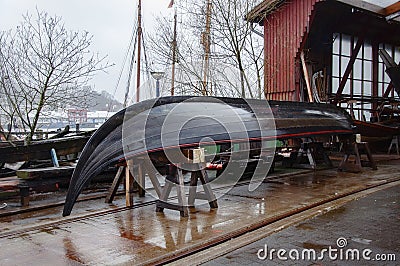 Small boatyard on the pier. Boat garage with boat on the roof Stock Photo