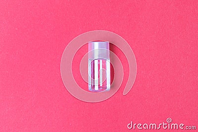 Small botlle with parfume on red colored paper background. top view Stock Photo