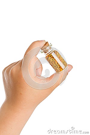 Small bottle with pollen in child hand Stock Photo