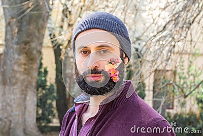 Man spring flowers blooming medical adhesive pink sakura beard adult face tape Stock Photo