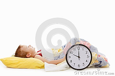 Boy with asleep clock in the bed , wake up concept Stock Photo
