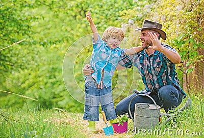 Small boy child help father in farming. happy earth day. Family tree nursering. Eco farm. watering can, pot and hoe Stock Photo