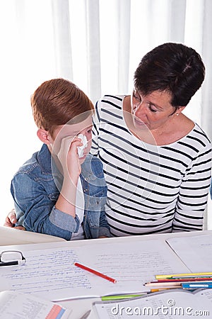 Small boy gets comforted by mother Stock Photo