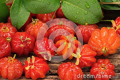 Small Brazilian fruit called pitanga - Suriname cherry in rustic wood background Stock Photo
