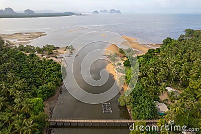 Small bridge passing small river to the sea Stock Photo