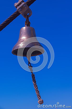 Small bronze bell on a sailing ship Stock Photo