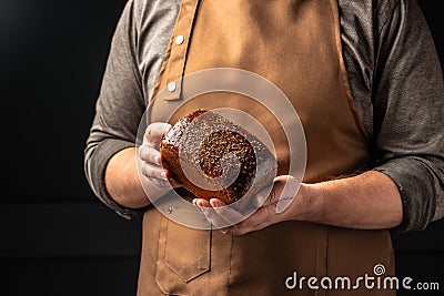 Small brown bread in hands, domestic cozy bakery pastry. Healthy food concept. place for text Stock Photo