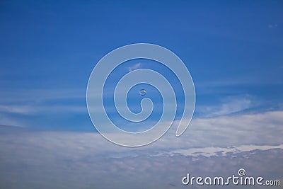 Small bubble flying on blue sky with clouds Stock Photo