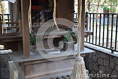 Small Buddhist Shrine with Bell-Ringing Rope Stock Photo