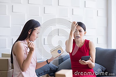 Small business asian woman owner depressed and headache while working at home office,Success start up entrepreneur SME online busi Stock Photo