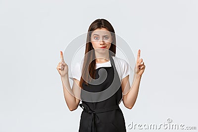 Small business, employees and coffee shop concept. Skeptical and disappointed female barista smirk unsatisfied and Stock Photo