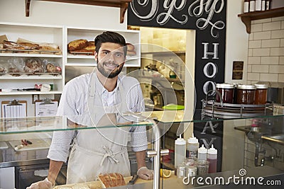 Small business owner behind the counter of a sandwich bar Stock Photo