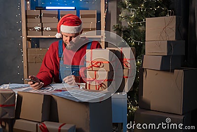 Small business owner delivery service and working packing box on Christmas, business owner santa working checking order Stock Photo