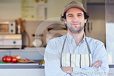 Small business owner smiling in front of his takeaway food busin Stock Photo