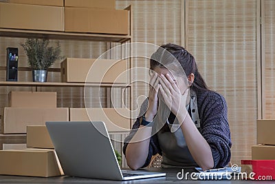 Small Business, Startup SME, Owner Entrepreneurs. Asian woman with unsuccess business online shopping crying and serious Stock Photo