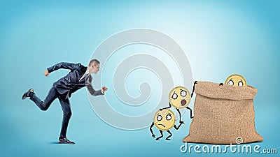 A small businessman running to a large full sack where many coins with arms and legs are getting in. Stock Photo