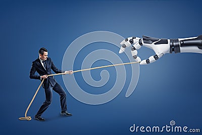 A small businessman tugs a long rope competing with a giant robotic hand. Stock Photo
