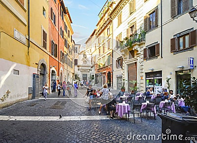 A small cafe with outdoor seating in historic Rome Italy Editorial Stock Photo