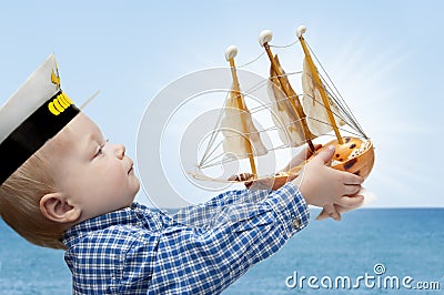 Small captain with the ship Stock Photo