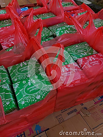 small cardboard filled with snacks in a red plastic bag Editorial Stock Photo