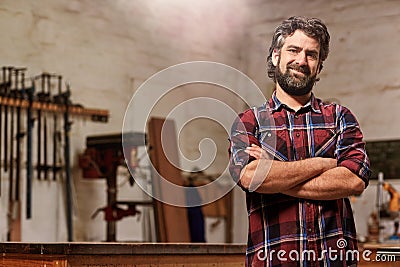 Small carpentry business owner smiling with arms crossed Stock Photo