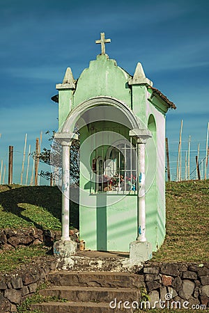 Small Catholic shrine amid a rural landscape Stock Photo