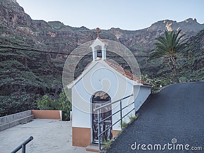 Small chapel at Guarimiar village. At hiking trail through Barranco de Guarimiar Gorge. Green mountain canyon slopes Stock Photo