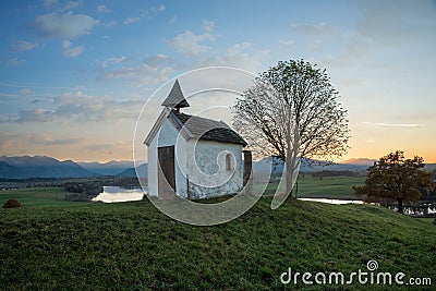 Small chapel on the hill, dreamy sunset scenery upper bavaria Stock Photo