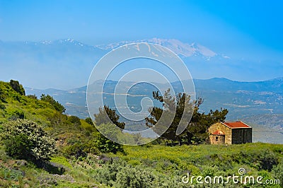 Small chapel on a hill with ida snowy mountain Stock Photo