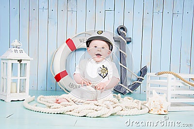 A small cheerful captain in a maritime interior Stock Photo