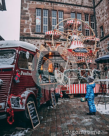 A small child admiring a food truck on christmas Editorial Stock Photo