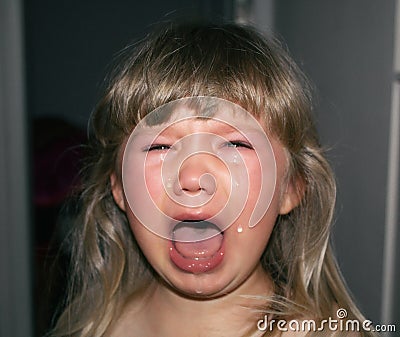 A small child is crying with tears and drooling. Children`s hysteria. Stock Photo