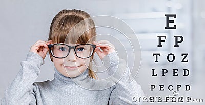 A small child with glasses at ophthalmologic diagnostic center Stock Photo