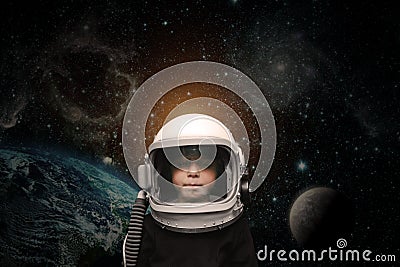 A small child imagines himself to be an astronaut in an astronaut`s helmet Stock Photo