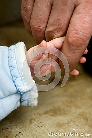 The small child keeping for a finger of the father Stock Photo