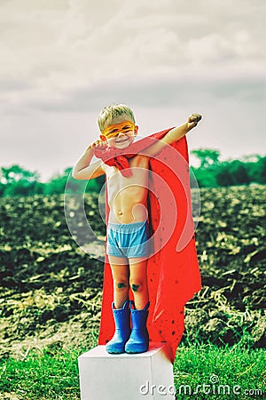 A small child plays a superhero. Stock Photo