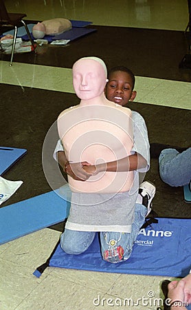 Small child practices the heimlish maneuver Editorial Stock Photo