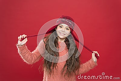 Small child ready for winter. kid fashion. Warm knitting tips. happy girl in earflap hat. holiday activity outdoor Stock Photo