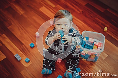 A little boy sits on the floor and plays with the designer Stock Photo