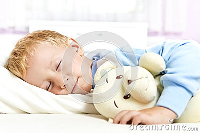 Small child sleeping in bed Stock Photo