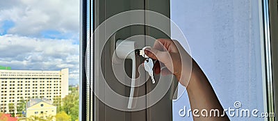 Small child is trying to open window in apartment Stock Photo